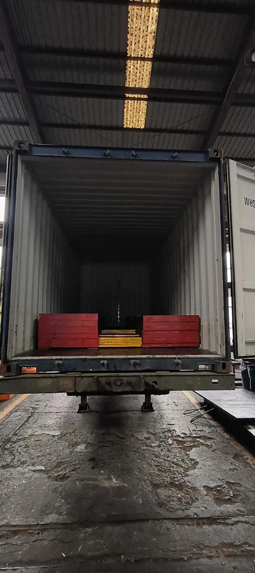 Container loaded with packed steel blocks